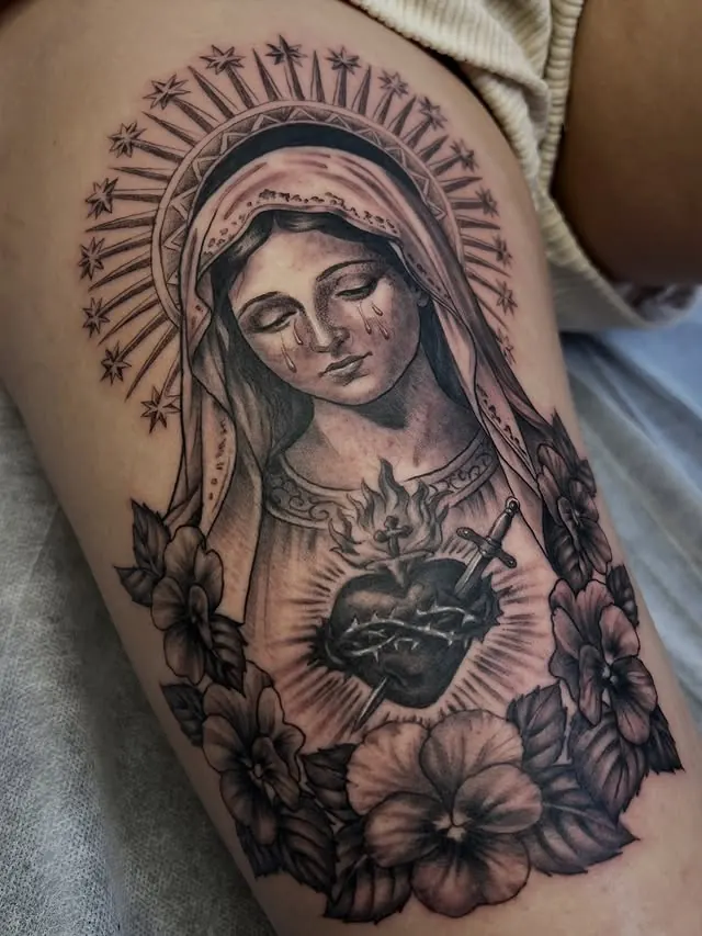 Black and grey Lady of Sorrow tattoo with violet flowers