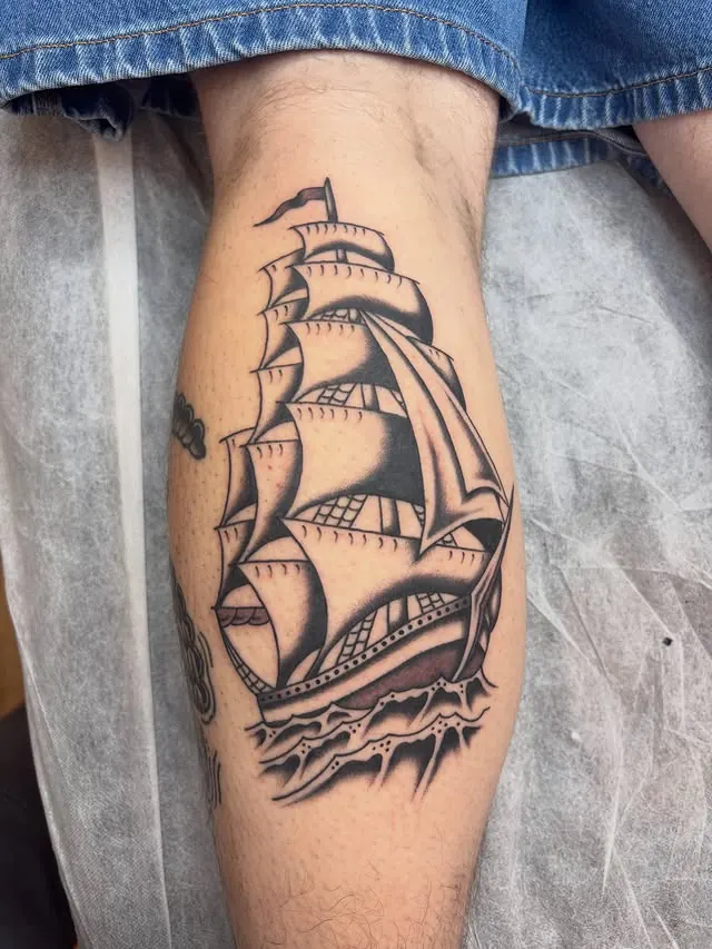 Traditional ship tattoo added to a patchwork sleeve
