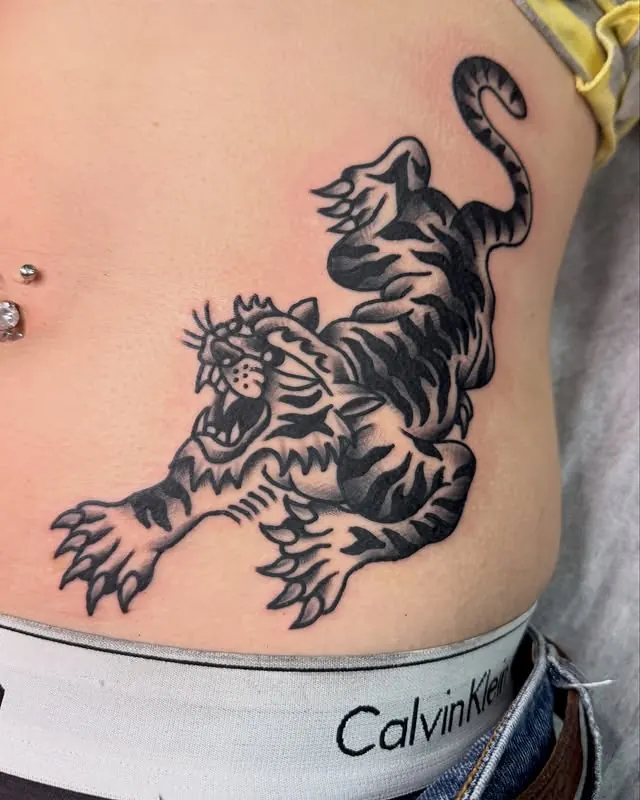 Large traditional tiger tattoo on the stomach